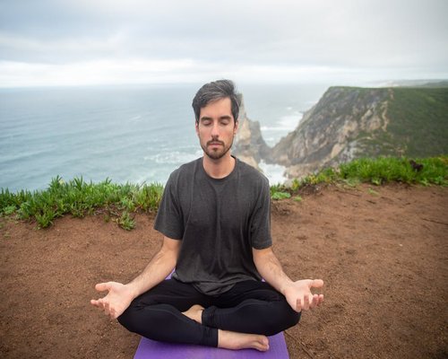 Man practicing mindfulness and deep breathing outdoors